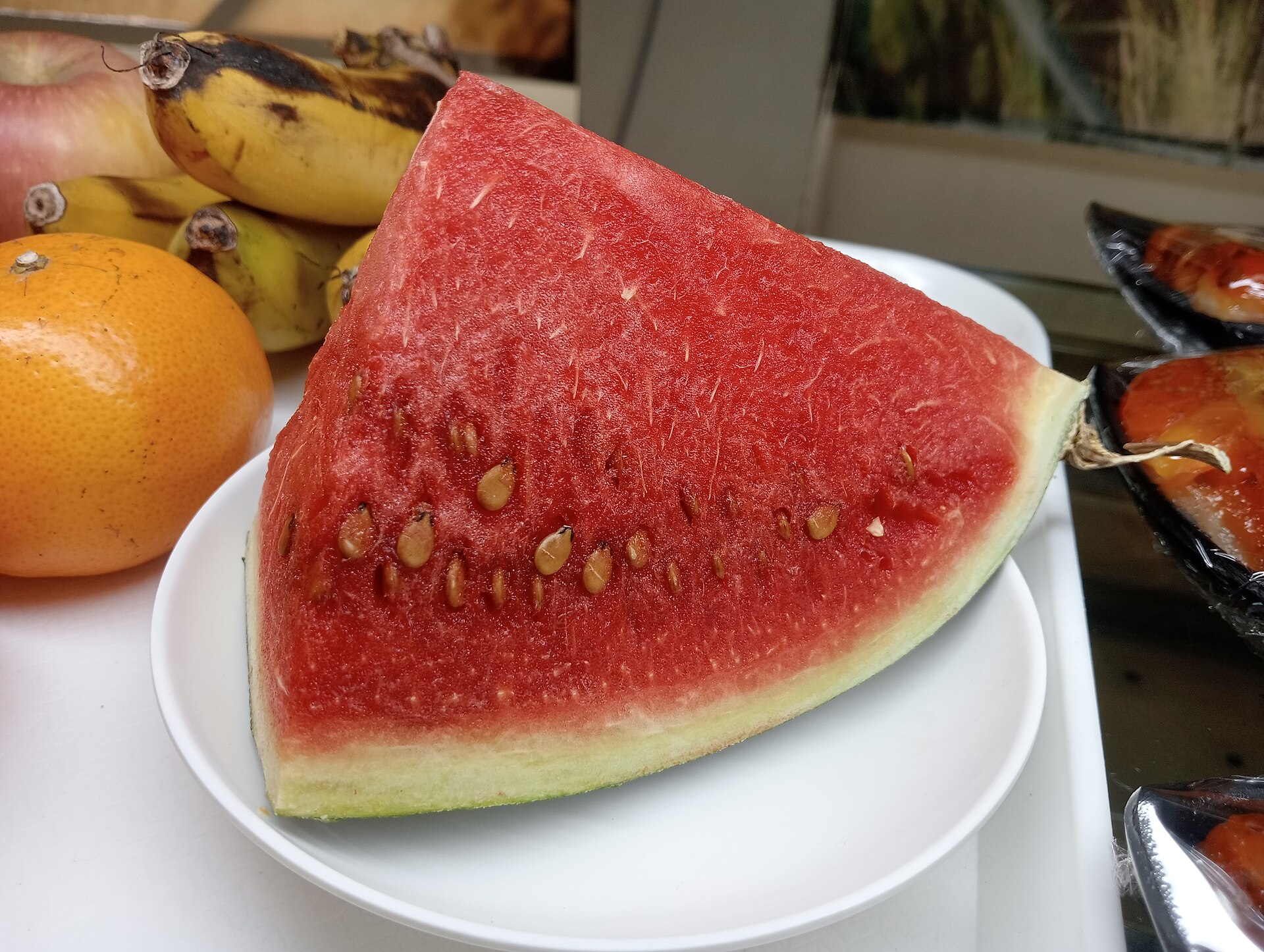 A ripe slice of red watermelon with seeds